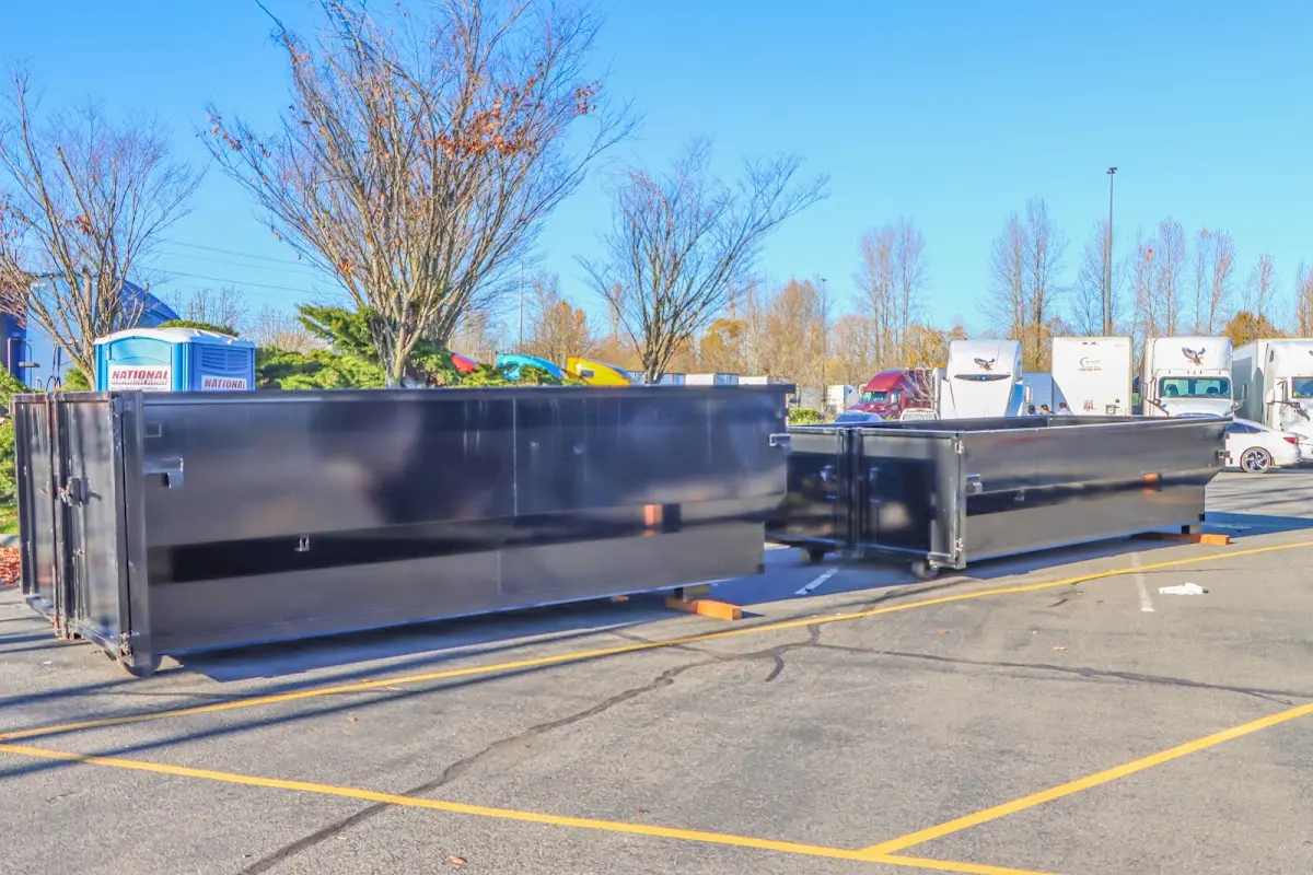 Professional dumpster rental service with roll-off container on residential driveway in Laketown